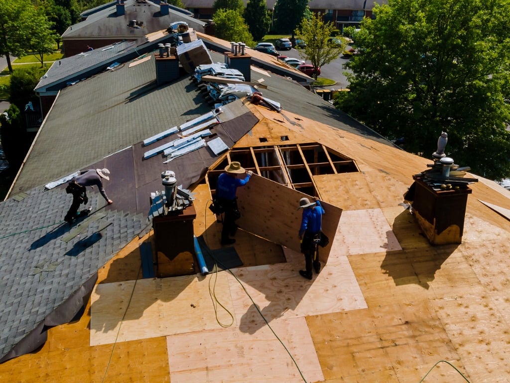 Roofing crew replacing a residential roof deck